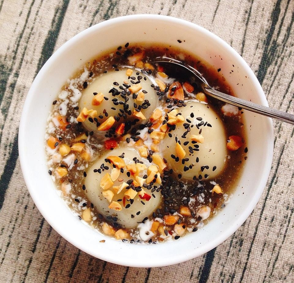 Bowl of warm glutinous rice dumplings in ginger syrup with peanuts