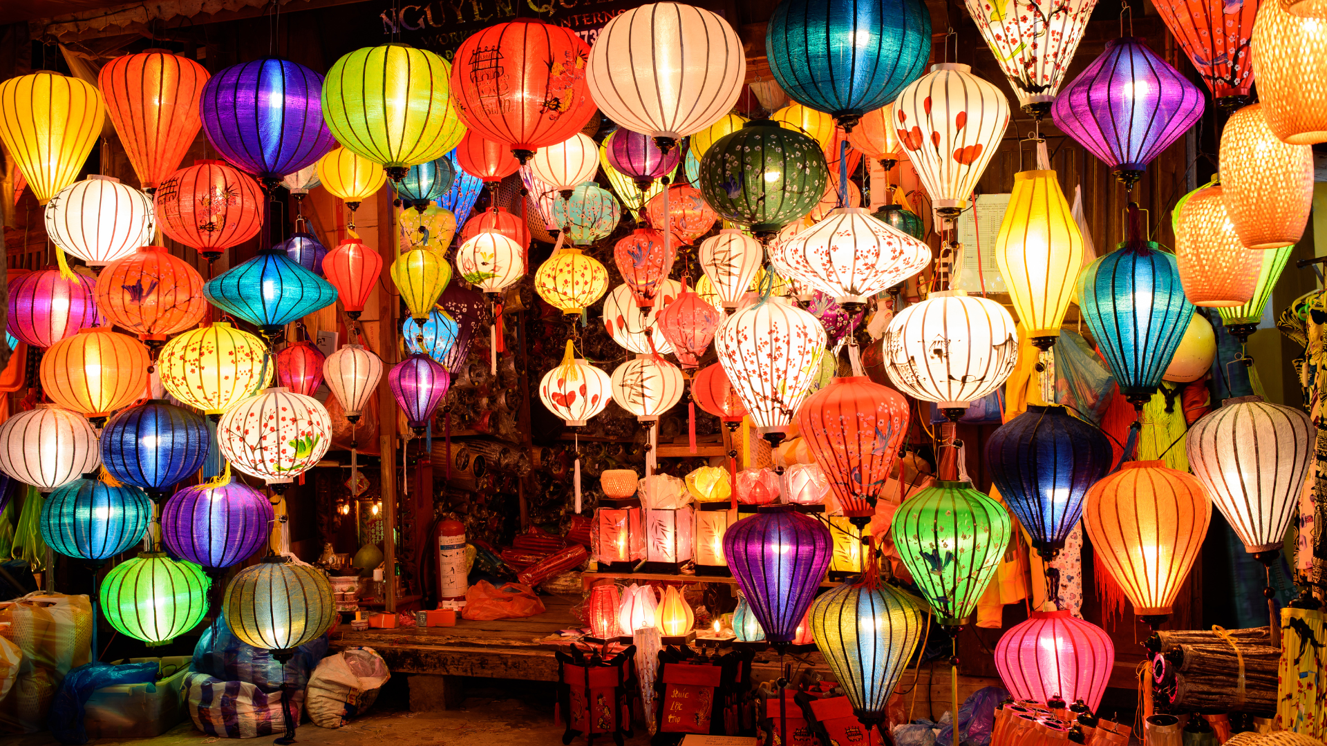 Vibrant silk lanterns glowing over evening crowds in Hoi An Ancient Town